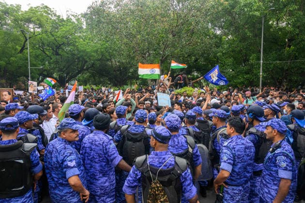 July 20, 2026, New Delhi, New Delhi, India: NEW DELHI, India Ã¢â‚¬ Rapid Action Force (RAF) personnel form a line as protesters wave national flags and hold placards at Jantar Mantar during demonstrations by the Cockroach Janata Party (CJP) demanding the resignation of Education Minister Dharmendra Pradhan over alleged irregularities in the NEET-UG exam, July 20, 2026. New Delhi India - ZUMAm184 20260720_zip_m184_039 Copyright: xAnkitxRoyxMajumderx