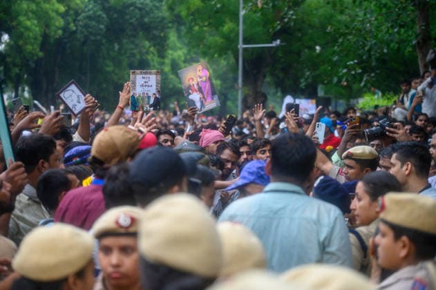 July 20, 2026, New Delhi, New Delhi, India: NEW DELHI, India Ã¢â‚¬ Protesters hold up a copy of India s Constitution and portraits as police officers stand amid the crowd at Jantar Mantar during demonstrations by the Cockroach Janata Party (CJP) demanding the resignation of Education Minister Dharmendra Pradhan over alleged irregularities in the NEET-UG exam, July 20, 2026. New Delhi India - ZUMAm184 20260720_zip_m184_035 Copyright: xAnkitxRoyxMajumderx