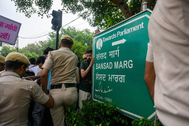 July 20, 2026, New Delhi, New Delhi, India: NEW DELHI, India Ã¢â‚¬ Protesters are surrounded by police on all sides near a Towards Parliament, Sansad Marg signpost during demonstrations by the Cockroach Janata Party (CJP) demanding the resignation of Education Minister Dharmendra Pradhan over alleged irregularities in the NEET-UG exam, July 20, 2026. New Delhi India  - ZUMAm184 20260720_zip_m184_058 Copyright: xAnkitxRoyxMajumderx