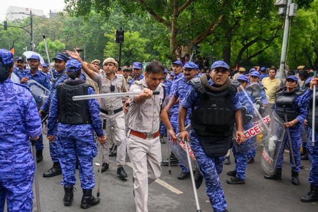July 20, 2026, New Delhi, New Delhi, India: NEW DELHI, India Ã¢â‚¬ A senior police officer swings a baton as Rapid Action Force (RAF) personnel move in a lathi-charge on protesters on Sansad Marg during demonstrations by the Cockroach Janata Party (CJP) demanding the resignation of Education Minister Dharmendra Pradhan over alleged irregularities in the NEET-UG exam, July 20, 2026. New Delhi India  - ZUMAm184 20260720_zip_m184_059 Copyright: xAnkitxRoyxMajumderx