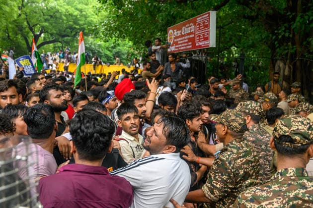 July 20, 2026, New Delhi, New Delhi, India: NEW DELHI, India Ã¢â‚¬ Security personnel push through a dense crowd of protesters waving national flags near Sansad Marg during demonstrations by the Cockroach Janata Party (CJP) demanding the resignation of Education Minister Dharmendra Pradhan over alleged irregularities in the NEET-UG exam, July 20, 2026. New Delhi India  - ZUMAm184 20260720_zip_m184_062 Copyright: xAnkitxRoyxMajumderx
