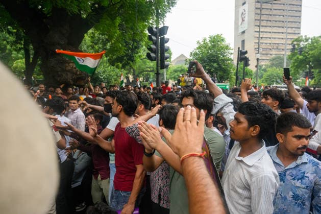 July 20, 2026, New Delhi, New Delhi, India: NEW DELHI, India Ã¢â‚¬ Protesters wave national flags and raise their hands as they march near Sansad Marg during demonstrations by the Cockroach Janata Party (CJP) demanding the resignation of Education Minister Dharmendra Pradhan over alleged irregularities in the NEET-UG exam, July 20, 2026. New Delhi India  - ZUMAm184 20260720_zip_m184_069 Copyright: xAnkitxRoyxMajumderx