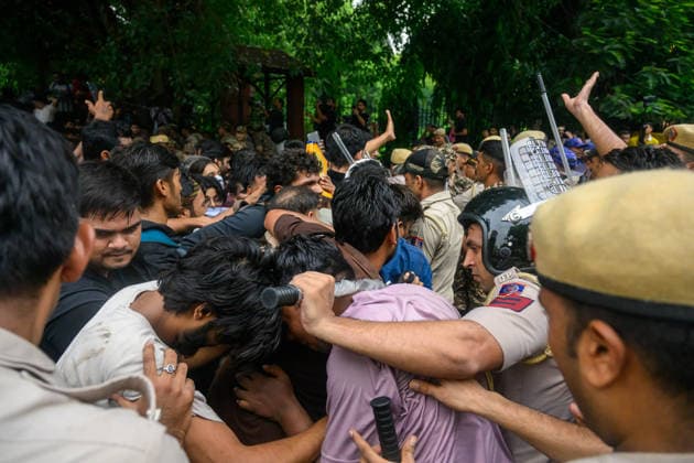 July 20, 2026, New Delhi, New Delhi, India: NEW DELHI, India Ã¢â‚¬ A police officer presses a baton against a protester s neck, pushing him backward, as officers and demonstrators scuffle near Sansad Marg during demonstrations by the Cockroach Janata Party (CJP) demanding the resignation of Education Minister Dharmendra Pradhan over alleged irregularities in the NEET-UG exam, July 20, 2026. New Delhi India  - ZUMAm184 20260720_zip_m184_074 Copyright: xAnkitxRoyxMajumderx