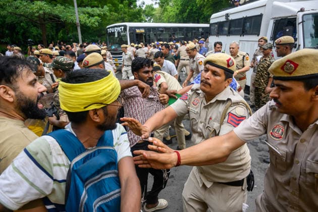 July 20, 2026, New Delhi, New Delhi, India: NEW DELHI, India Ã¢â‚¬ A police officer grabs hold of a protester to detain him as officers move through the crowd at Jantar Mantar during demonstrations by the Cockroach Janata Party (CJP) demanding the resignation of Education Minister Dharmendra Pradhan over alleged irregularities in the NEET-UG exam, July 20, 2026. New Delhi India - ZUMAm184 20260720_zip_m184_046 Copyright: xAnkitxRoyxMajumderx