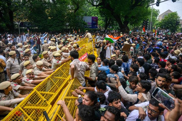 July 20, 2026, New Delhi, New Delhi, India: NEW DELHI, India Ã¢â‚¬ Delhi Police officers hold a barricade against protesters as the crowd waves national flags and placards during demonstrations by the Cockroach Janata Party (CJP) demanding the resignation of Education Minister Dharmendra Pradhan over alleged irregularities in the NEET-UG exam, July 20, 2026. New Delhi India  - ZUMAm184 20260720_zip_m184_100 Copyright: xAnkitxRoyxMajumderx