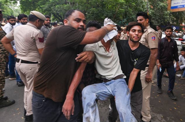 NEW DELHI, INDIA - JULY 20: An injured Cockroach Janata Party (CJP) supporter during a protest march, at Sansad Marg on July 20, 2026 in New Delhi, India. (Photo by Raj K Raj Hindustan Times) Delhi Police And Protestors Injured In Clash During Protest March