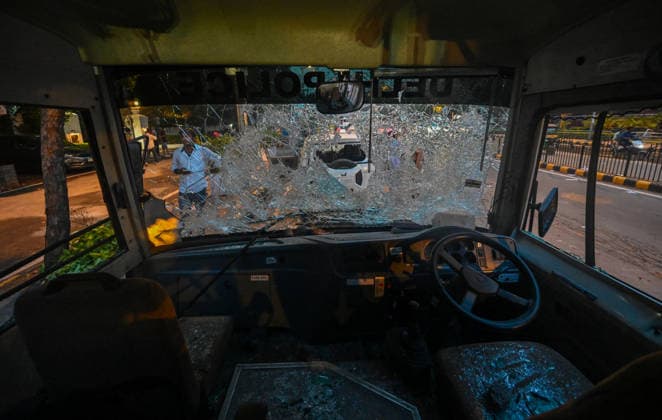 NEW DELHI, INDIA - JULY 20: A view of a police vehicle damaged during clashes involving CJP protesters on Janpath on July 20, 2026 in New Delhi, India. Protesters marching toward Parliament defied prohibitory orders under Section 163, leading to severe altercations with police. The clash resulted in nearly 50 police personnel injured and over 70 detentions. Delhi Police buses and SUVs were smashed. The march was organized to demand accountability for exam paper irregularities and the resignation of Education Minister Dharmendra Pradhan.(Photo by Raj K Raj Hindustan Times) Delhi Police Vehicles Damaged Following CJP Protest March
