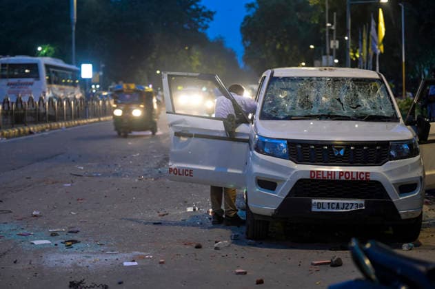 NEW DELHI, INDIA - JULY 20: A view of a police vehicle damaged during clashes involving CJP protesters on Janpath on July 20, 2026 in New Delhi, India. Protesters marching toward Parliament defied prohibitory orders under Section 163, leading to severe altercations with police. The clash resulted in nearly 50 police personnel injured and over 70 detentions. Delhi Police buses and SUVs were smashed. The march was organized to demand accountability for exam paper irregularities and the resignation of Education Minister Dharmendra Pradhan.(Photo by Raj K Raj Hindustan Times) Delhi Police Vehicles Damaged Following CJP Protest March