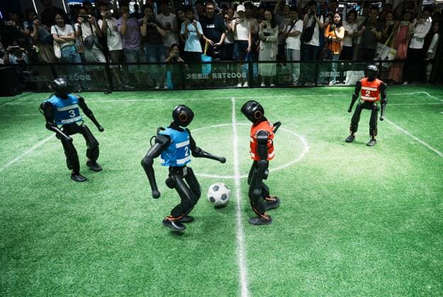 SHANGHAI, CHINA - JULY 20: Spectators watch Booster Robotics Booster T2 robots competing in a 2-on-2 football match during the 2026 World Artificial Intelligence Conference on July 20, 2026 in Shanghai, China. The 2026 World AI Conference and High-Level Meeting on Global AI Governance scheduled from July 17 to July 20 showcases exhibitions of smart devices, AI plus culture and entertainment experiences, and a wide range of cutting-edge AI products, among which a range of humanoid robots and AI-powered dexterous hands as one of the highlights.  Copyright: xVCGx 111655541730
