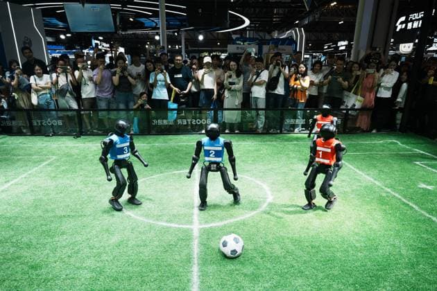 SHANGHAI, CHINA - JULY 20: Spectators watch Booster Robotics Booster T2 robots competing in a 2-on-2 football match during the 2026 World Artificial Intelligence Conference on July 20, 2026 in Shanghai, China. The 2026 World AI Conference and High-Level Meeting on Global AI Governance scheduled from July 17 to July 20 showcases exhibitions of smart devices, AI plus culture and entertainment experiences, and a wide range of cutting-edge AI products, among which a range of humanoid robots and AI-powered dexterous hands as one of the highlights.  Copyright: xVCGx 111655541733