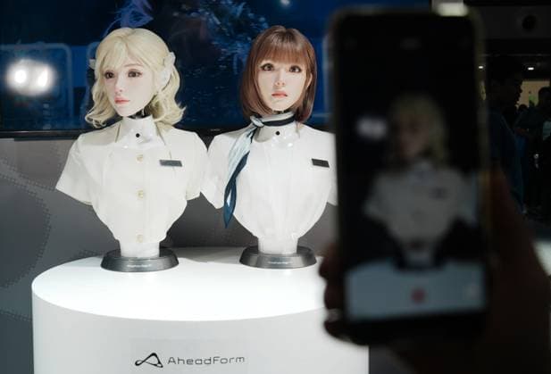 SHANGHAI, CHINA - JULY 20: A visitor takes photos of a female robot at the 2026 World AI Conference on July 20, 2026 in Shanghai, China. The conference showcases latest advancements in artificial intelligence and robotics technologies.  Copyright: xVCGx 111655410367
