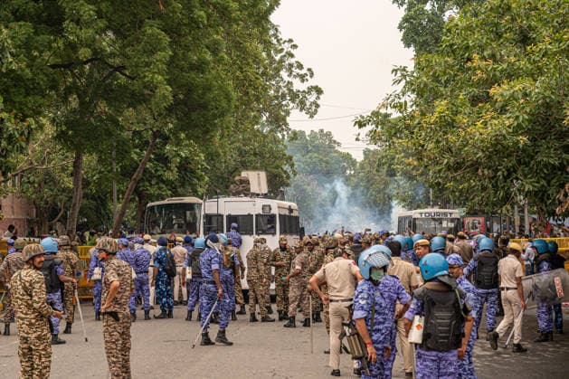 Cockroach Janta Party (CJP) march to Parliament in New Delhi, India - 20 Jul 2027 Rapid Action Force (RAF) personnel fire tear gas shells to disperse protesters marching towards Parliament during a demonstration organized by the Cockroach Janta Party (CJP). The protesters had been staging a sit-in at the protest site for nearly 30 days before announcing a march toward the Indian Parliament. They demanded the resignation of Union Education Minister Dharmendra Pradhan over alleged examination irregularities and called for the release of activist Sonam Wangchuk who was taken into custody and hospitalized following a prolonged hunger strike. New Delhi India Copyright: xPradeepxGaurx xSOPAxImagesx DSC_2086