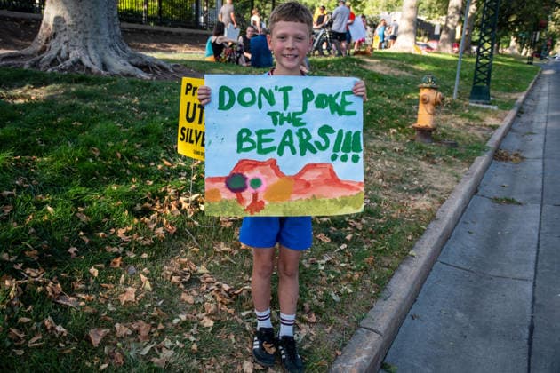 July 20, 2026, Salt Lake City, Utah, USA: A young protester holds a hand-painted sign reading DON T POKE THE BEARS!!! featuring artwork of rock formations on the sidewalk outside the Utah Governor s Mansion in Salt Lake City, Utah, on Monday, July 20, 2026. The community rally was organized to protest executive actions drastically reducing the boundaries of the Bears Ears and Grand Staircase-Escalante national monuments. Salt Lake City USA - ZUMAm292 20260720_znp_m292_002 Copyright: xCharlesxMcClintockxWilsonx