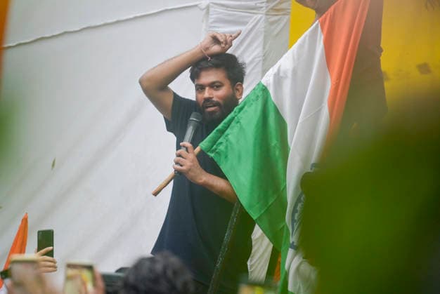 NEW DELHI, INDIA - JULY 20: Cockroach Janta Party founder Abhijeet Dipke waves national flag and copy of constitution during the CJP protest march towards Parliament from Jantar Mantar demanding resignation of Union Education Minister Dharmendra Pradhan over NEET Paper leak on July 20, 2026 in New Delhi, India. (Photo by Raj K Raj Hindustan Times) Cockroach Janata Party Protest March To Parliament