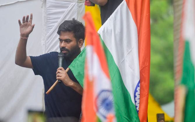 NEW DELHI, INDIA - JULY 20: Cockroach Janta Party founder Abhijeet Dipke waves national flag and copy of constitution during the CJP protest march towards Parliament from Jantar Mantar demanding resignation of Union Education Minister Dharmendra Pradhan over NEET Paper leak on July 20, 2026 in New Delhi, India. (Photo by Raj K Raj Hindustan Times) Cockroach Janata Party Protest March To Parliament