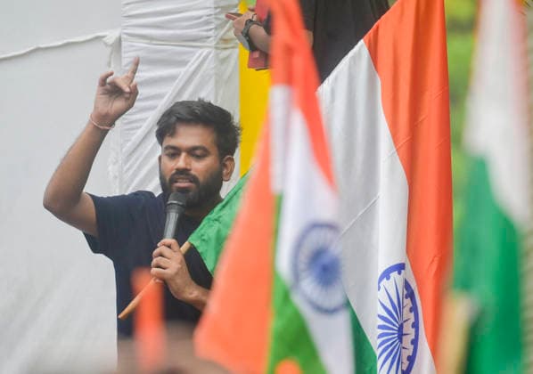 NEW DELHI, INDIA - JULY 20: Cockroach Janta Party founder Abhijeet Dipke waves national flag and copy of constitution during the CJP protest march towards Parliament from Jantar Mantar demanding resignation of Union Education Minister Dharmendra Pradhan over NEET Paper leak on July 20, 2026 in New Delhi, India. (Photo by Raj K Raj Hindustan Times) Cockroach Janata Party Protest March To Parliament