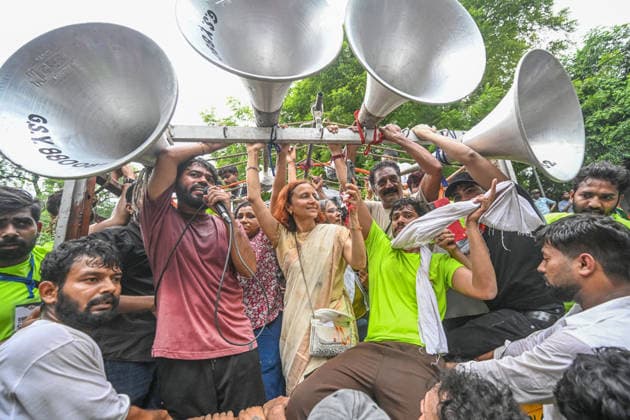 NEW DELHI, INDIA - JULY 20: Abhijeet Dipke, founder of the Cockroach Janta Party (CJP), along with Gitanjali J. Angmo, wife of climate activist Sonam Wangchuk, participates in a protest march towards Parliament from Jantar Mantar on July 20, 2026 in New Delhi, India. The march, held amid heavy security arrangements, drew thousands of supporters demanding action over alleged examination paper leaks and reforms in the education system. (Photo by Sanchit Khanna Hindustan Times) Cockroach Janata Party Protest March To Parliament