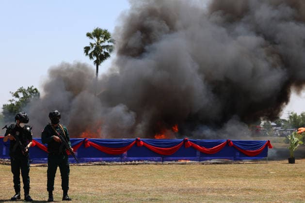 (260721) -- KANDAL, July 21, 2026 -- Anti-drug police officers stand guard during a drug-burning ceremony in Kandal province, Cambodia, July 21, 2026. Cambodia destroyed 5.62 tons of illicit drugs and precursor chemicals valued at 500 million U.S. dollars on Tuesday, Deputy Prime Minister and Interior Minister Sar Sokha said. (Photo by Sovannara Xinhua) CAMBODIA-KANDAL-DRUG-BURNING CEREMONY WuxChangwei 