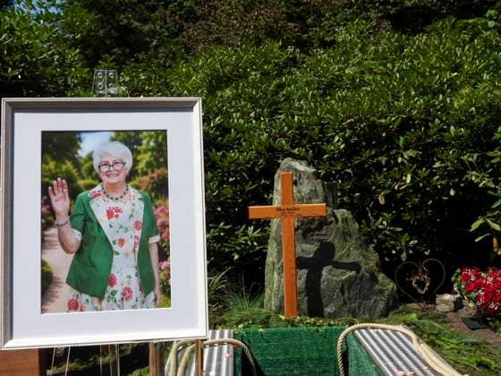 CNTV OHLSDORF- Blumen und Trauer Kraenze liegen vor einem Holzkreuz und dem Bild der versorbenen auf der Grabstelle Grab von Ilka Seeler die Ehefrau vom verstorbenen Fußballer Uwe Seeler wurde heute neben ihrem Mann beerdigt 21.07.2026 Hamburg - Ohlsdorf Hamburg Deutschland *** CNTV OHLSDORF Flowers and funeral wreaths lie in front of a wooden cross and a portrait of the deceased at the gravesite. The grave of Ilka Seeler, wife of the late soccer player Uwe Seeler, was laid to rest today next to her husband. July 21, 2026, Hamburg-Ohlsdorf, Hamburg Germany