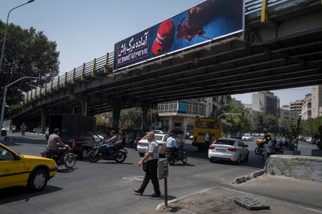 Anti‘Trump Messaging Appears On Billboards In Tehran An Iranian man crosses an avenue beneath an anti-U.S. President Donald Trump billboard in downtown Tehran, Iran, on July 21, 2026, amid renewed conflicts between Iran and the United States in southern Iran. MORTEZA NIKOUBAZL NurPhoto Tehran Tehran Iran  Copyright: xMortezaxNikoubazlx originalFilename: nikoubazl-antitrum260721_npBMq.jpg