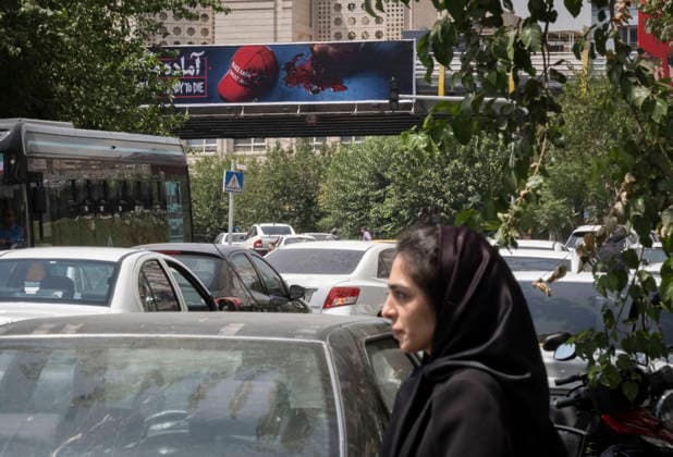 Anti‘Trump Messaging Appears On Billboards In Tehran An Iranian woman stands on a street-side beneath an anti-U.S. President Donald Trump billboard in downtown Tehran, Iran, on July 21, 2026, amid renewed conflicts between Iran and the United States in southern Iran. MORTEZA NIKOUBAZL NurPhoto Tehran Tehran Iran  Copyright: xMortezaxNikoubazlx originalFilename: nikoubazl-antitrum260721_npIa2.jpg
