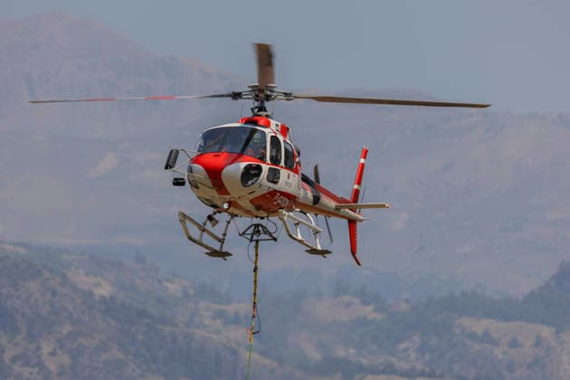 Argentiere La Bessee Wildfire - France A privately operated helicopter contracted by the French government flies with a water bucket during wildfire suppression operations near L Argentiere la Bessee, The aircraft collects and drops water on inaccessible fire fronts to support firefighters battling the wildfire in steep mountainous terrain, Hautes Alpes, France, July 21, 2026. Photo by Thibaut Durand ABACAPRESS.COM Argentiere La Besse Provence-Alpes-Cote d Azur France  Copyright: xDurandxThibaut ABACAx