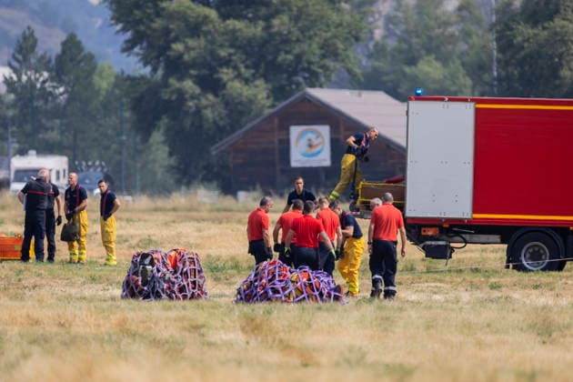 Argentiere La Bessee Wildfire - France Firefighters unload equipment from a logistics truck during wildfire operations near L Argentiere la Bessee, emergency crews prepare and organize material before deployment to the fire line as efforts continue to contain the wildfire. Hautes Alpes, France, July 21, 2026. Photo by Thibaut Durand ABACAPRESS.COM Argentiere La Besse Provence-Alpes-Cote d Azur France  Copyright: xDurandxThibaut ABACAx