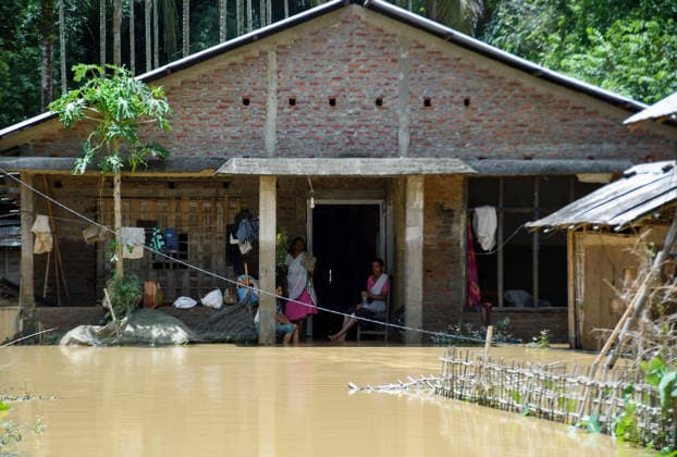 Floodwaters Inundate Houses in Assam™s Jorhat, Villagers Assess Damage Jorhat Assam , Jul 21 (ANI): Flood-affected villagers look at floodwaters after their houses were inundated at Teok, in Jorhat on Tuesday. Jorhat Assam India Copyright: xANIx ANI_20260721392