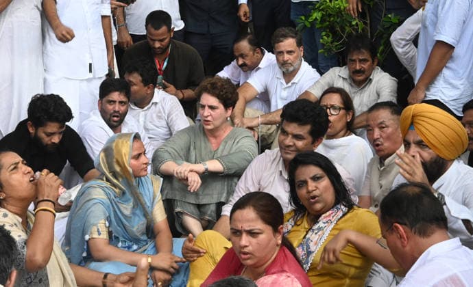 NEW DELHI, INDIA - JULY 21: Leader of Opposition in the Lok Sabha Rahul Gandhi with Priyanka Gandhi Vadra, Kerala Chief Minister VD Satheesan, Congress MP KC Venugopal, and others, stages a sit-in protest near the Prime Minister s residence in solidarity with students protesting over alleged irregularities in the NEET examination, on July 21, 2026 in New Delhi, India. The spontaneous demonstration at Lok Kalyan Marg unfolded a day after security forces used tear gas and lathi charges to disperse student marchers led by the Cockroach Janata Party (CJP) near Parliament Street. Rahul Gandhi demanded the immediate resignation of Union Education Minister Dharmendra Pradhan and an urgent, dedicated debate in Parliament regarding the NEET paper l