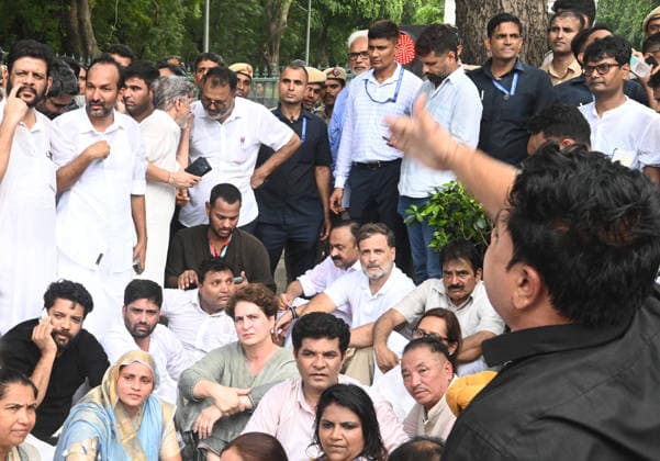 NEW DELHI, INDIA - JULY 21: Leader of Opposition in the Lok Sabha Rahul Gandhi with Priyanka Gandhi Vadra, Kerala Chief Minister VD Satheesan, Congress MP KC Venugopal, and others, stages a sit-in protest near the Prime Minister s residence in solidarity with students protesting over alleged irregularities in the NEET examination, on July 21, 2026 in New Delhi, India. The spontaneous demonstration at Lok Kalyan Marg unfolded a day after security forces used tear gas and lathi charges to disperse student marchers led by the Cockroach Janata Party (CJP) near Parliament Street. Rahul Gandhi demanded the immediate resignation of Union Education Minister Dharmendra Pradhan and an urgent, dedicated debate in Parliament regarding the NEET paper l