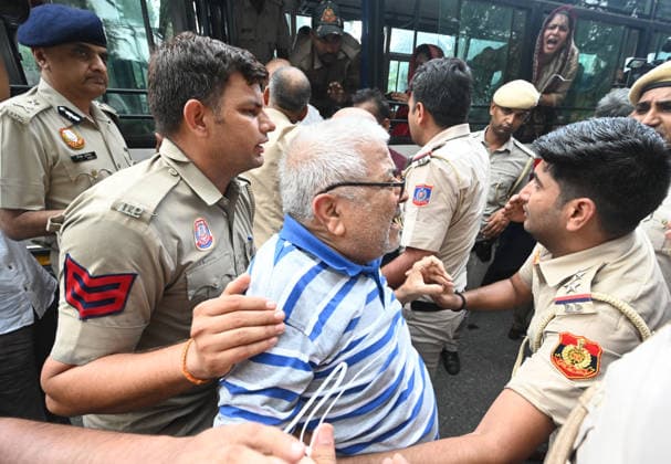 NEW DELHI, INDIA - JULY 21: Delhi Police Detained top congress Party Leaders during the Leader of Opposition in the Lok Sabha Rahul Gandhi and others, stages a sit-in protest near the Prime Minister s residence in solidarity with students protesting over alleged irregularities in the NEET examination, on July 21, 2026 in New Delhi, India. The spontaneous demonstration at Lok Kalyan Marg unfolded a day after security forces used tear gas and lathi charges to disperse student marchers led by the Cockroach Janata Party (CJP) near Parliament Street. Rahul Gandhi demanded the immediate resignation of Union Education Minister Dharmendra Pradhan and an urgent, dedicated debate in Parliament regarding the NEET paper leak controversy. (Photo by