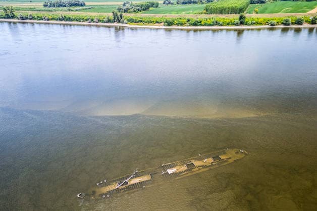Low water reveals remains of century-old ship on Croatia s Danube An aerial view shows the remains of a ship believed to be more than a century old after record-low water levels in the Danube River exposed the wreck in Opatovac, Croatia, on July 21, 2026. The vessel is believed to have sunk between the two World Wars.  DavidxJerkovic PIXSELL
