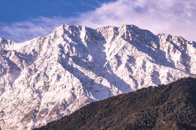 Creative Highlights World View of the Dhauladhar Mountains in Himachal Pradesh, India, with a blue sky dotted with clouds. Nagri Himachal Pradesh India