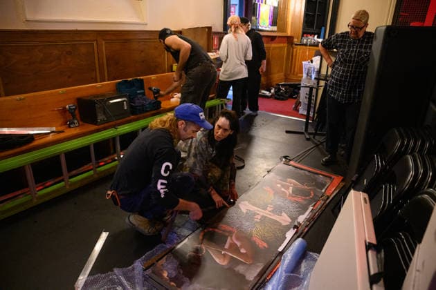 DIVINE PLAYHOUSE EVICTION, Devine Playhouse founder and creative director Kat Dopper (centre) inspectas artworks as the clean and pack up at the former church turned LGBTQ arts space, the Devine Playhouse, in Sydney, Wednesday, July 22, 2026. The group has been forced out of the space after the owners of the deconsecrated church in Sydney s CBD have terminated the lease following complaints from some members of the Christian community. ( NO ARCHIVING SYDNEY NEW SOUTH WALES AUSTRALIA  Copyright: xDANxHIMBRECHTSx 20260722114358507624