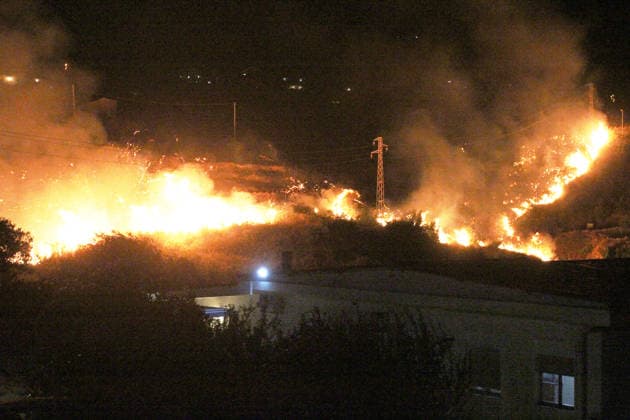 Wildfires continue in Italian island of Sicily PALERMO, ITALY - JULY 22: Wildfires that broke out in several parts of the Italian island of Sicily continue overnight, fueled by strong winds, as firefighters, civil protection teams and forestry crews press on with efforts to contain the blazes near Palermo, Sicily, Italy on July 22, 2026. The wildfires, which started yesterday on the slopes of Mount Longa near the city of Palermo, spread rapidly due to the wind and burned throughout the night. Alberto Lo Bianco Anadolu Palermo Italy. Editorial use only. Please get in touch for any other usage.  Copyright: x2026xAnadoluxAlbertoxLoxBiancox