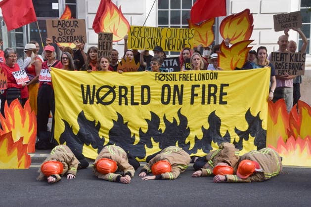 July 22, 2026, London, England, United Kingdom: Climate activists from Fossil Free London dressed as firefighters stage a protest outside the Department for Energy Security and Net Zero calling on the new Energy Secretary Miatta Fahnbulleh and the new UK Prime Minister Andy Burnham to stop the Rosebank oil and gas field in the North Sea. London United Kingdom - ZUMAv130 20260722_zip_v130_013 Copyright: xVukxValcicx