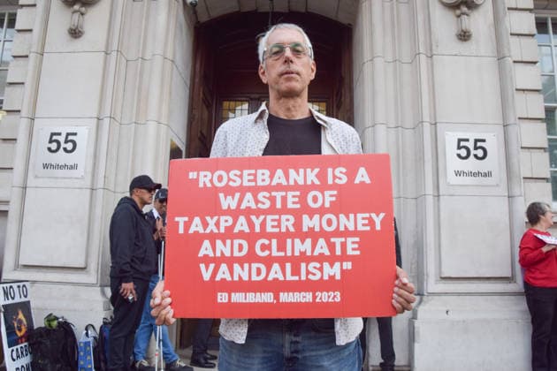 July 22, 2026, London, England, United Kingdom: A climate activist holds a placard with a quote attributed to former Energy Secretary Ed Miliband during a protest outside the Department for Energy Security and Net Zero calling on the UK government to stop the Rosebank oil and gas field in the North Sea. London United Kingdom - ZUMAv130 20260722_zip_v130_018 Copyright: xVukxValcicx