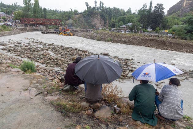 July 22, 2026, Budgam, Jammu And Kashmir, India: People look at the Sukhnag River near the site of a shopping complex damaged by flash floods following heavy rain in Beerwah. The severe weather leaves at least 22 people dead in the Poonch and Rajouri districts. Budgam India - ZUMAa205 20260722_zip_a205_006 Copyright: xAdilxAbassx