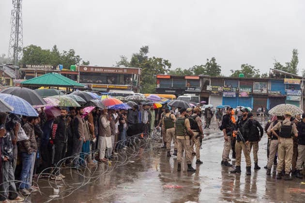 July 22, 2026, Budgam, Jammu And Kashmir, India: People look at a shopping complex damaged by flash floods following heavy rain in Beerwah. The severe weather leaves at least 22 people dead in the Poonch and Rajouri districts, forces the closure of educational institutions until July 26, and leads to the suspension of the Amarnath Yatra. Budgam India - ZUMAa205 20260722_zip_a205_012 Copyright: xAdilxAbassx