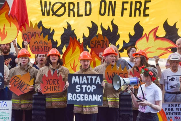 July 22, 2026, London, United Kingdom: Climate activists from the group Fossil Free London dressed as firefighters hold placards during a protest outside the Department for Energy Security and Net Zero (DESNZ) calling on the new Energy Secretary Miatta Fahnbulleh and the new UK Prime Minister Andy Burnham to stop the Rosebank oil and gas field in the North Sea. London United Kingdom  - ZUMAs197 20260722_aaa_s197_036 Copyright: xVukxValcicx