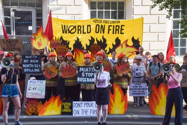 July 22, 2026, London, United Kingdom: Climate activists from the group Fossil Free London dressed as firefighters hold placards during a protest outside the Department for Energy Security and Net Zero (DESNZ) calling on the new Energy Secretary Miatta Fahnbulleh and the new UK Prime Minister Andy Burnham to stop the Rosebank oil and gas field in the North Sea. London United Kingdom - ZUMAs197 20260722_aaa_s197_040 Copyright: xVukxValcicx