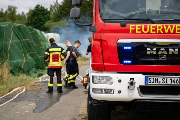 Polizeihubschrauber sucht nach Brandstiftern 200 Rundballen in Flammen 70 Einsatzkräfte im Einsatz Am 22.07.2026 brannten in Tiefenbach im Hunsrück gegen 13:00 Uhr rund 200 Rundballen an drei nahegelegenen Einsatzstellen. Zwei Brandstellen lagen im Wald, eine auf einem Sportplatz. Ein Polizeihubschrauber suchte das Gebiet nach möglichen Tätern ab, während die Polizei Fahrzeuge auf der Straße kontrollierte. Rund 70 Einsatzkräfte errichteten eine Riegelstellung zu angrenzenden Silageballen und dem Wald und ließen das Feuer kontrolliert abbrennen. Tiefenbach (Hunsrück) Rheinland-Pfalz Deutschland *** Police helicopter searches for arsonists; 200 round bales in flames; 70 emergency responders on the scene. On July 22, 2026, at