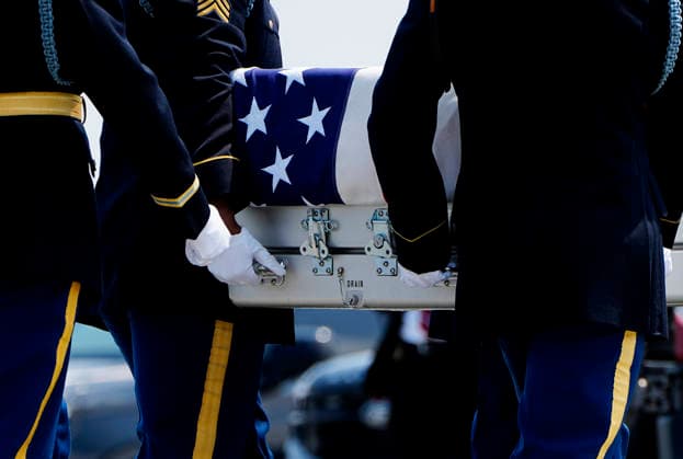 President Donald Trump watches as a U.S. Army carry team carries the transfer case containing the remains of Army Staff Sgt. Emmanuel Swinton during a dignified transfer at Dover Air Force Base in Dover, Delaware on Wednesday, July 22, 2026. Swinton, who was killed during a controlled detonation of an Iranian drone in Iraq, will receive a Bronze Star, Purple Heart, Combat Action Badge, and was posthumously promoted to staff sergeant.  DEL202607222005 BONNIExCASH