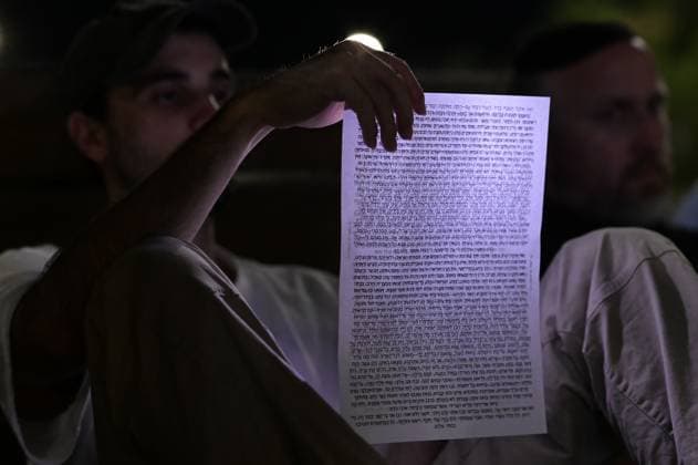 July 22, 2026, Tel-Aviv, Israel: TEL AVIV, ISRAEL Ã¢â‚¬ JULY 22, 2026: Dozens of Jewish worshippers gather at Dizengoff Square in central Tel Aviv for a public reading of the Book of Lamentations on the eve of Tisha B Av, the annual Jewish day of mourning commemorating the destruction of the First and Second Temples in Jerusalem. The observance is marked by prayers, fasting and the reading of biblical texts recalling the tragedies in Jewish history. Tel-Aviv Israel - ZUMAq101 20260722_zna_q101_222 Copyright: xTomerxNeubergx