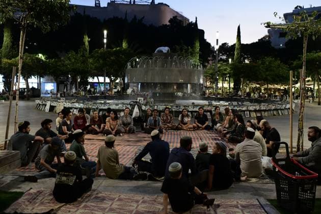 July 22, 2026, Tel-Aviv, Israel: TEL AVIV, ISRAEL Ã¢â‚¬ JULY 22, 2026: Dozens of Jewish worshippers gather at Dizengoff Square in central Tel Aviv for a public reading of the Book of Lamentations on the eve of Tisha B Av, the annual Jewish day of mourning commemorating the destruction of the First and Second Temples in Jerusalem. The observance is marked by prayers, fasting and the reading of biblical texts recalling the tragedies in Jewish history. Tel-Aviv Israel - ZUMAq101 20260722_zna_q101_224 Copyright: xTomerxNeubergx