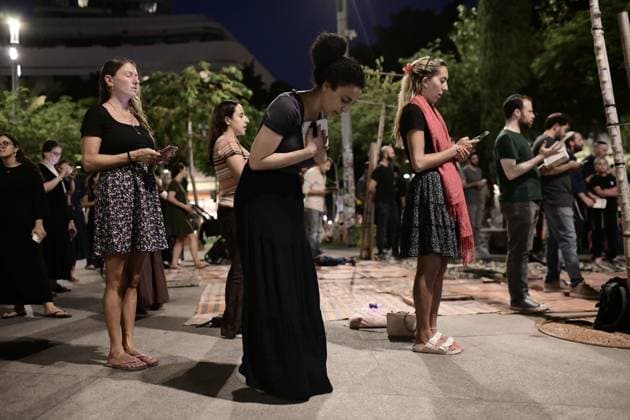 July 22, 2026, Tel-Aviv, Israel: TEL AVIV, ISRAEL Ã¢â‚¬ JULY 22, 2026: Dozens of Jewish worshippers gather at Dizengoff Square in central Tel Aviv for a public reading of the Book of Lamentations on the eve of Tisha B Av, the annual Jewish day of mourning commemorating the destruction of the First and Second Temples in Jerusalem. The observance is marked by prayers, fasting and the reading of biblical texts recalling the tragedies in Jewish history. Tel-Aviv Israel  - ZUMAq101 20260722_zna_q101_233 Copyright: xTomerxNeubergx