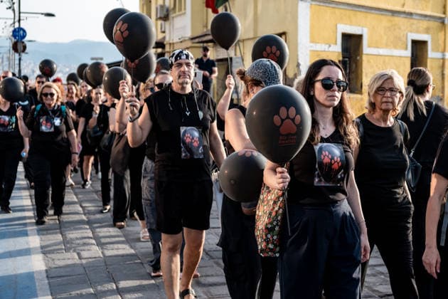 July 22, 2026, Izmir, Turkey: Animal rights activists seen walking on streets while holding black balloons with animal footsteps during their silent march. Animal rights advocates held a silent march in Izmir, Turkey, to call for the protection of stray animals and their right to life. Following the march, participants issued a statement urging humane and permanent solutions for stray animals while calling on the public to defend the right to life and adopt animals from shelters or the streets. Izmir Turkey - ZUMAs197 20260722_aaa_s197_493 Copyright: xMuratxKocabasx