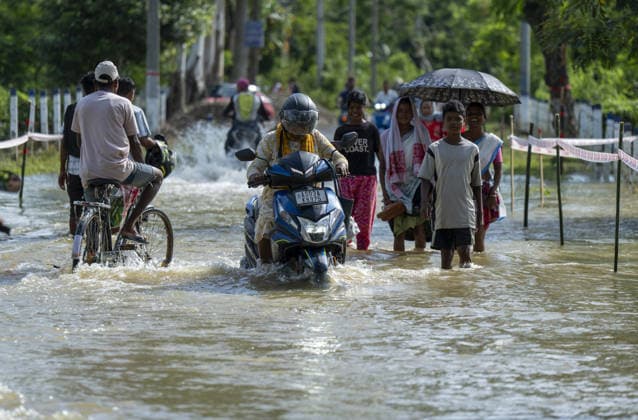 Flood in Indian Northeastern State Assam JORHAT, INDIA - JULY 22: Residents wade through a flooded road as rising floodwaters inundate a residential area following heavy rainfall, on July 22, 2026 in Jorhat, India. The flood situation in Assam remained critical, with more than 630,000 people affected across 21 districts. The state’s death toll has risen to 12. David Talukdar Anadolu Jorhat India. Editorial use only. Please get in touch for any other usage.  Copyright: x2026xAnadoluxDavidxTalukdarx