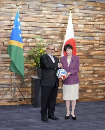 Japan-Solomon Islands summit Japanese Prime Minister Sanae Takaichi (R) shakes hands with Solomon Islands Prime Minister Matthew Cooper Wale after presenting a football to him at the premier s office in Tokyo on July 23, 2026.  A14AA0005624018P