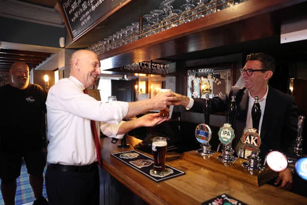 Prime Minister Andy Burnham visits the Hare pub 23 07 2026. Harlow, United Kingdom. Prime Minister Andy Burnham pours a pint for John Healey, Chancellor of the Exchequer as they visit the Hare pub as the government announces a 20 percent cut in business rates for pubs, clubs and live music venues., Credit:Simon Dawson B66 Avalon United Kingdom, Essex, Harlow, First Bus s Bath Depot  Copyright: xSimonxDawsonx xB66x xAvalonx 1118062193